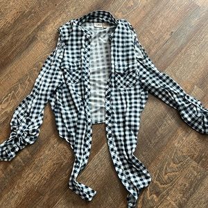 Long sleeve shirt with holes that your shoulders are out. Two pockets on front